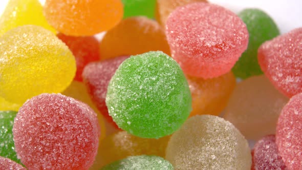 Assorted sugary marmalade candies close-up. Translucent candied jelly round shape. Macro