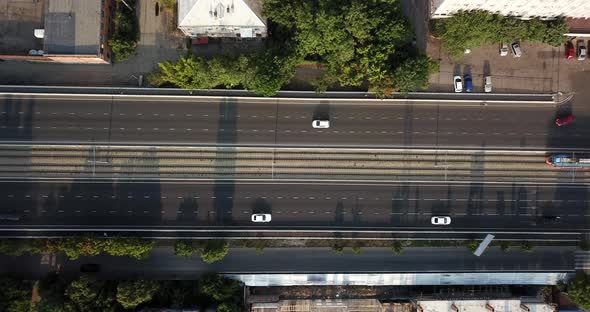 Aerial Top Down View of Traffic Jam on a Car Bridge and Moving Tram.