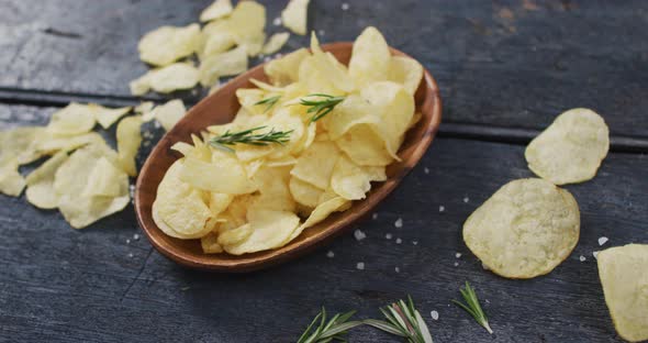 Close up view of potato chips in a bowl with copy space on wooden surface