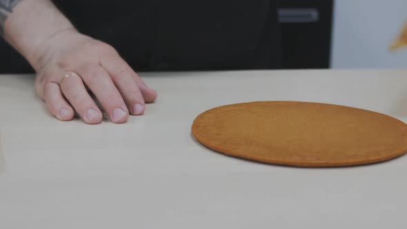 Baker Pastry Chef Hands Overturns Fresh Baked Cakes for Honey Cake on the Table