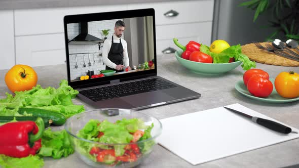 Laptop Computer with Man Food Blogger Tells Teaches Students Slices Tomato