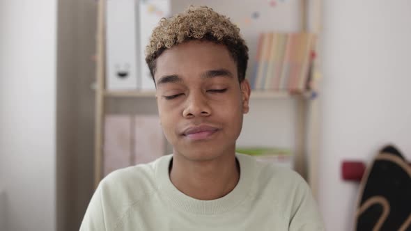 Screen View of Teenager Boy Listening His Teacher Through a Video Call on Laptop