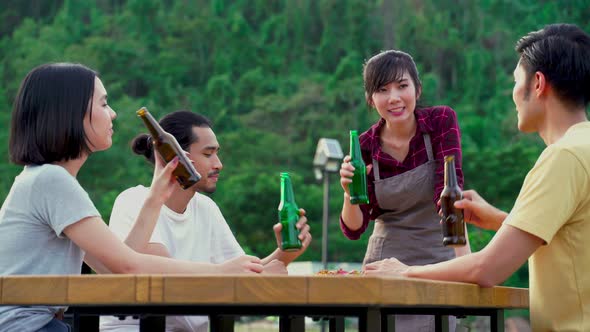 Group of Asian man and woman are having fun in new year party outdoor in the evening together.