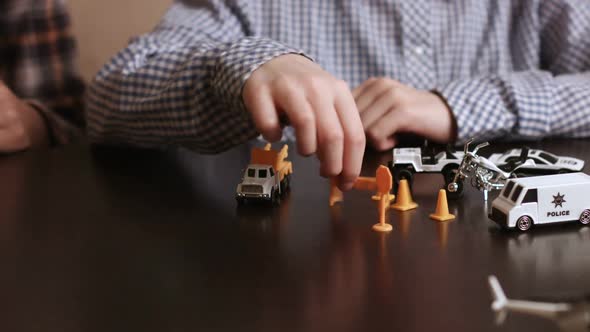 Boy's Hand Moves Toy Vehicle.