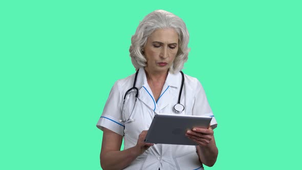 Overhelmed Female Doctor Using Digital Tablet