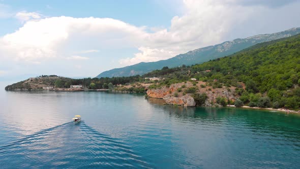 Aerial shot of Macedonia coast. Clif and beautiful water around Ohrid Lake in Southern Europe. Boat