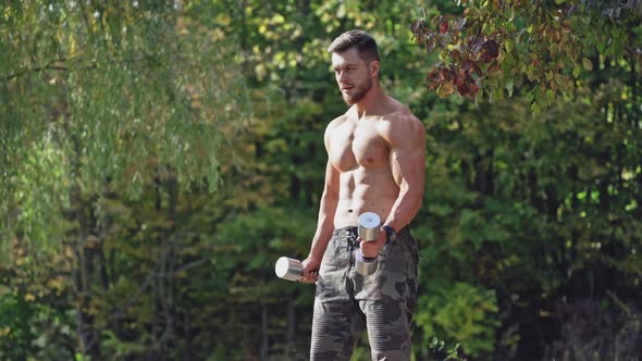 Bearded shirtless man doing workout in nature.