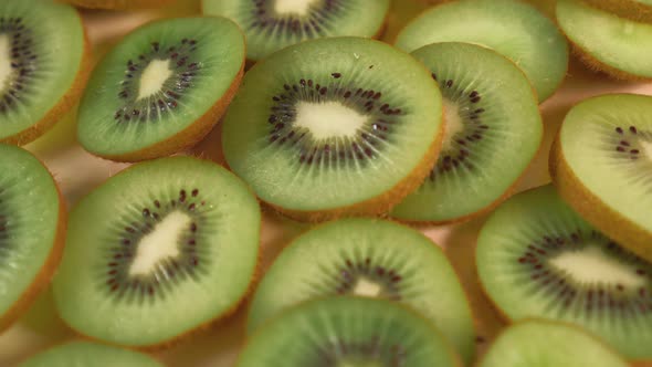 Rotation of chopped slices of ripe fresh kiwi fruit 