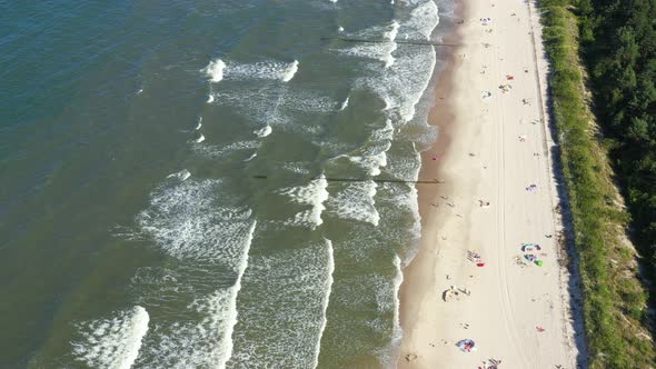 Baltic Sea coast beach Hel aerial drone top view 4K UHD video. People on the beach. Aerial View