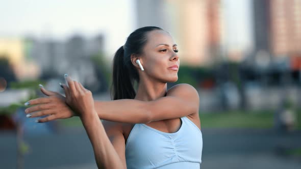 Happy Young Fitness Woman Warming Up Training Outdoor at Sunset Cityscape Enjoying Healthy Lifestyle