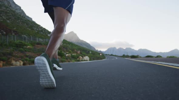 Rear view of african american man running on the road