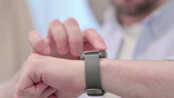 Portrait of Young Man Using Smart Watch