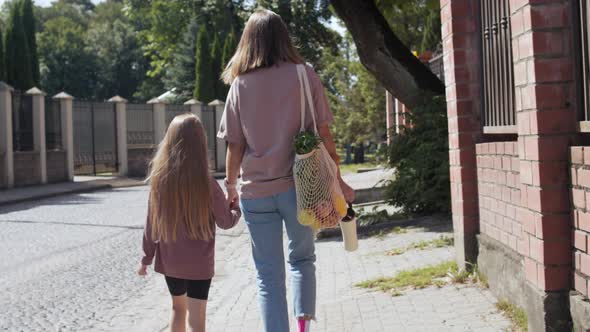 Mother and daughter walk after shopping