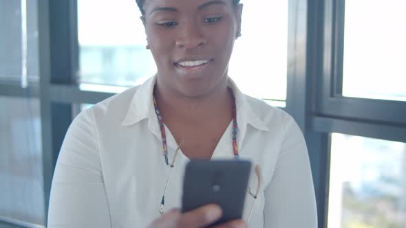Cheerful Focused African American Office Worker Texting Message