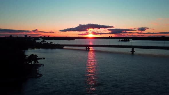 Aerial view of the sunset behind the Lapinlahti bridge, summer evening in Helsinki, Finland - tracki