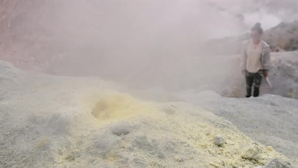 A Young Woman Tourist on an Excursion Walks Past the Fumaroles From Which Hot Steam in the Crater of