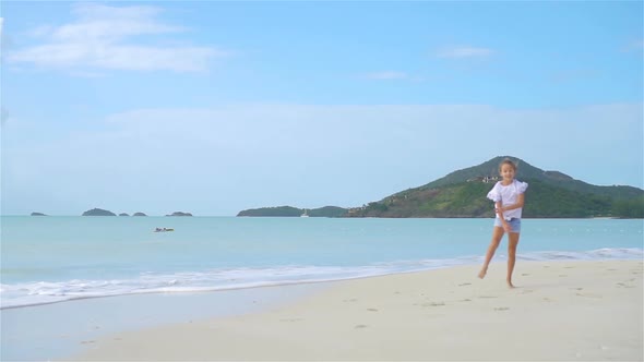 Adorable Little Girl During Beach Vacation Having Fun