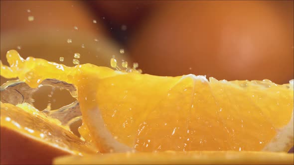 Slow Motion Shot of Orange Juice Splashing Through Orange Slices at 1400Fps