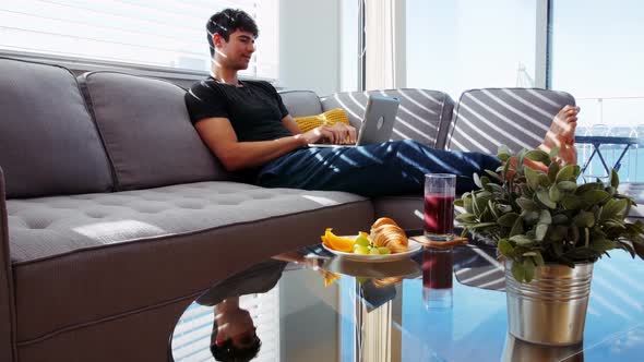 Man using laptop in living room 4k