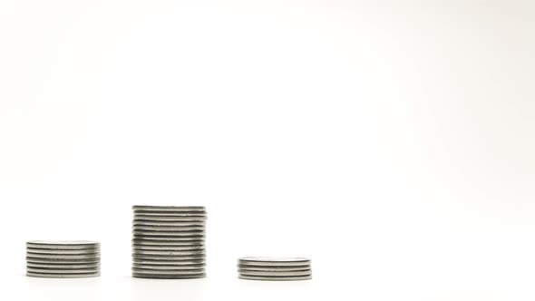 Silver Coins on Stacks Are Growing on White Background Stop Motion Animation