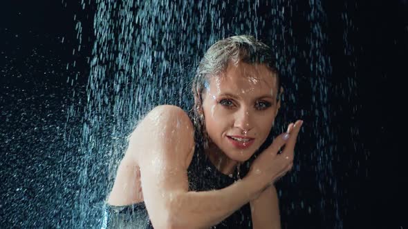 Portrait Beauty Feminine Dance Under Drops of Water Rain in Dark Slow Motion