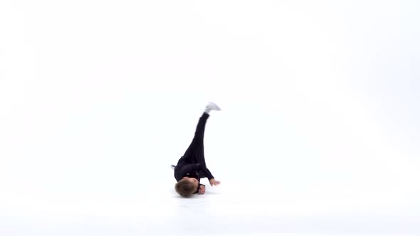 Little Boy Is Dancing a Modern Dance on the White Background in Black Leather Jackets and Jeans