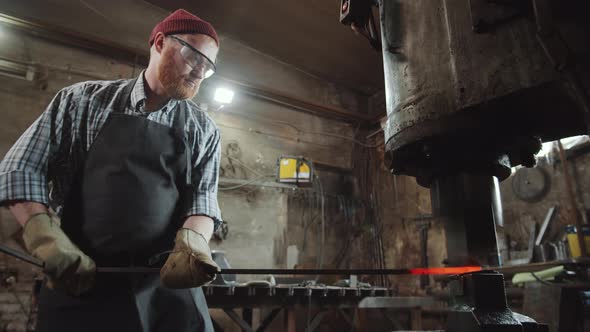 Blacksmith Using Pneumatic Forging Hammer at Work