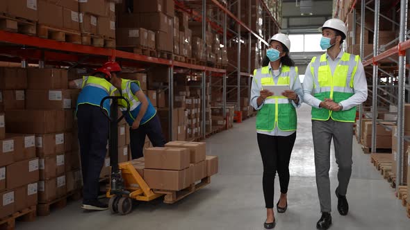 Storehouse Employees Using Tablet for Stocktaking