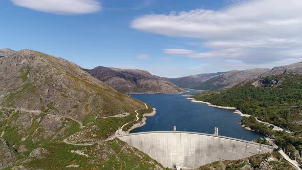 Modern Dam Reservoir on Blue Lake Waters Generate Alternative Energy in Highland Wild Area