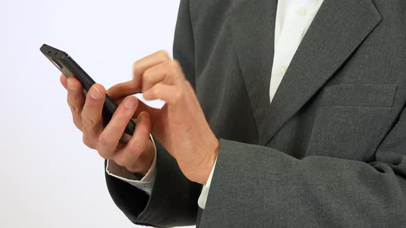 An Elderly Man Works on a Smartphone - Closeup on the Hands From the Side - White Screen Studio