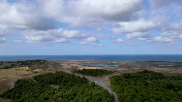 Drone flight over the north Istanbul forest. Cloudy sky, blue sea and green nature