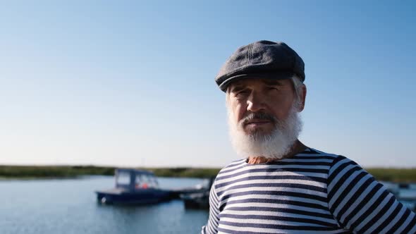 Portrait of an Old Man with a White Beard Looking at the Camera Then in the Distance While Standing