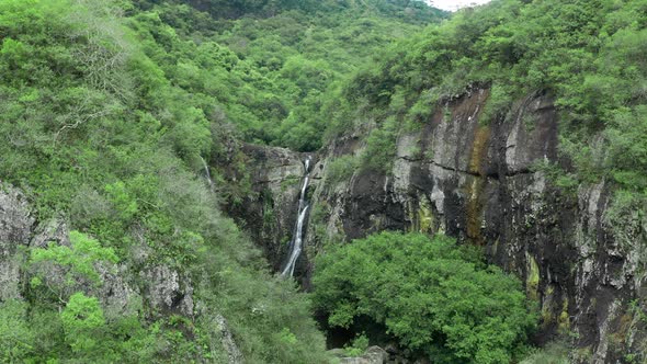 Camera is Flying Above Waterfall in Tropical Forest