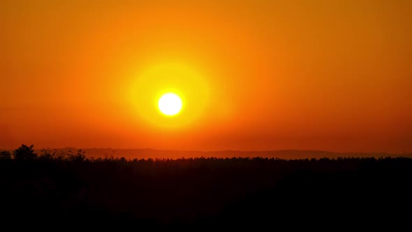 Timelapse Sunset in the Sky Big Bright Yellow Sun Moves Down on the Horizon