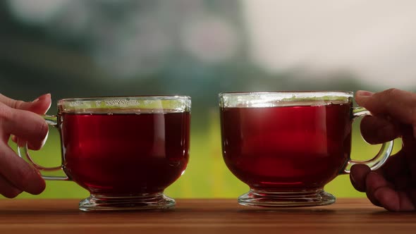 Red Fruit Tea in Glass Cups on a Wooden Table