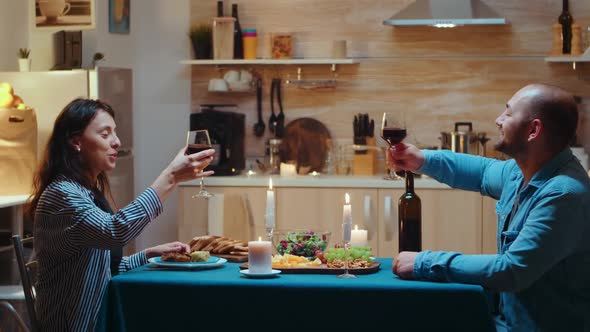 Couple Raising Wine Glass