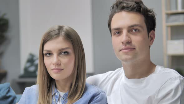 Positive Young Couple Looking at Camera