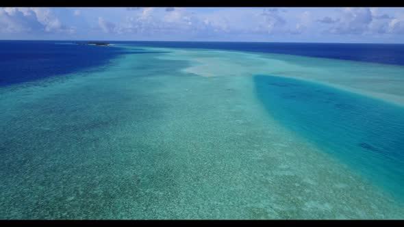 Aerial above landscape of tropical seashore beach vacation by blue lagoon with white sand background