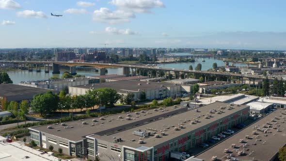 Bird's Eye View Of Vancouver Cityscape With Marine Drive SkyTrain Station And North Arm Bridge In Br