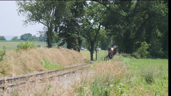 Steam Train Puffing Along Amish Countryside