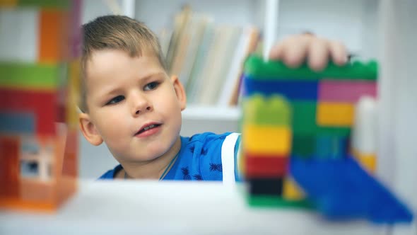 Kid Boy Playing Toy Blocks on Floor at Home