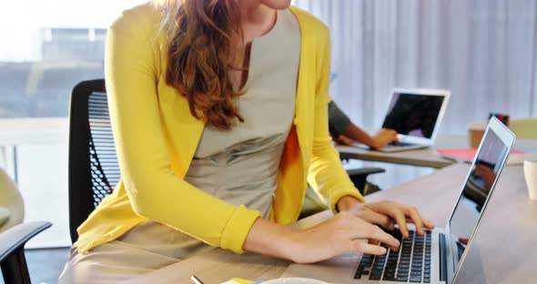 Businesswoman working on laptop at desk