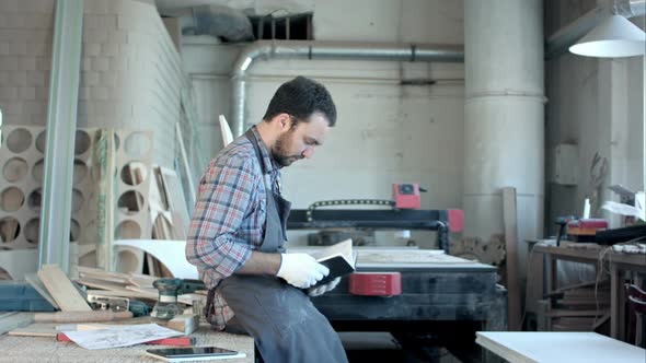 Bearded Carpenter at His Workshop Reading Diary