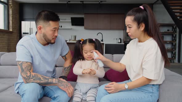 Asian Parents Educating Baby Daughter to Hygiene