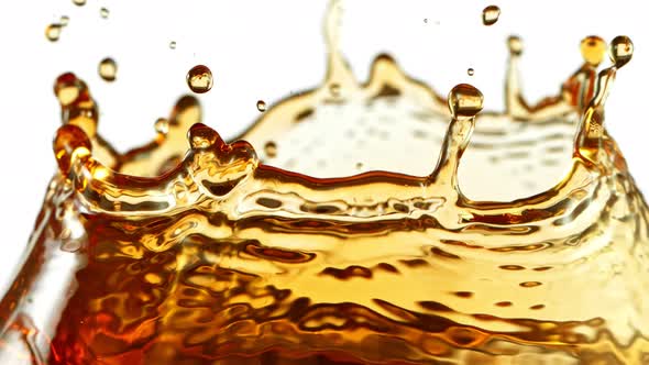 Super Slow Motion Shot of Ice Tea Splash Isolated on White Background at 1000Fps.