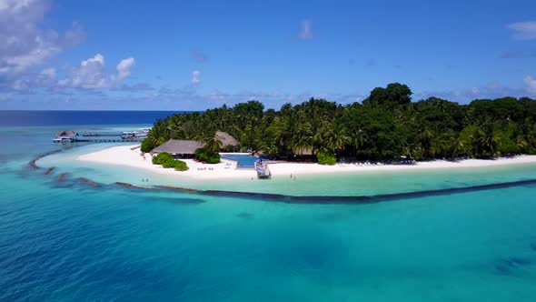 Aerial top down scenery of tranquil coast beach adventure by blue ocean with bright sandy background