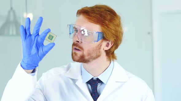 Astonished Scientist Examining New Chip of Computer