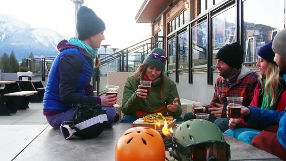 Friends interacting while toasting a glass of drink