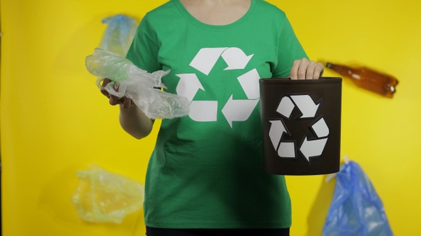 Unrecognizable Woman Put Cellophane Package in Bin Dump. Save Ecology. Plastic Nature Pollution