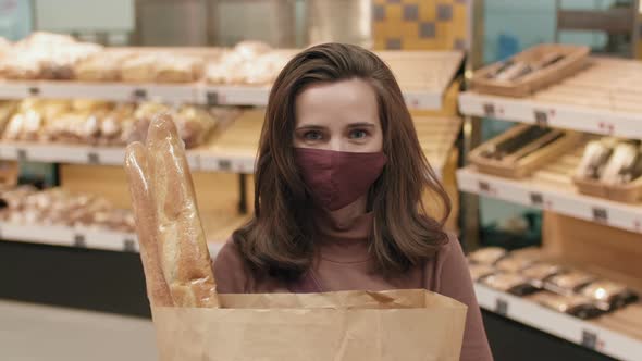 Portrait Of Female Customer With Fresh Baguettes